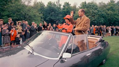 Britain's Queen Elizabeth II, with her husband Prince Philip, in an open topped car as they leave an event, in Paris, on May 16, 1972. The Queen is on a four day official visit to France. (AP Photo)